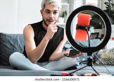 Transgender influencer streaming online makeup video tutorial on social media at home - Lgbt, gay, gender fluid concept - Powered by Shutterstock