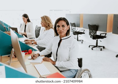 Transgender Latin Woman On Wheelchair Working With Computer At The Office In Mexico Latin America