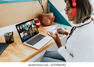 Transgender Latin Woman On Wheelchair On Video Call Working With Computer At The Office In Mexico Latin America