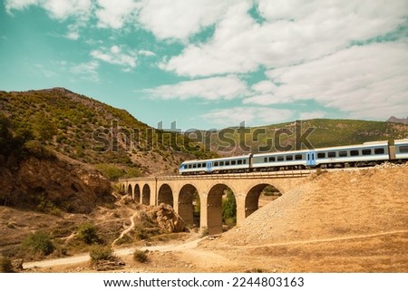 The Trans-Iranian Railway. A railway bridge at Mazanderan Province. A train is passing over a bridge in the mountainous region of Iran.