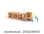 Transitioning from 2024 to 2025 with wooden blocks and miniature people. new year 2025 concept.