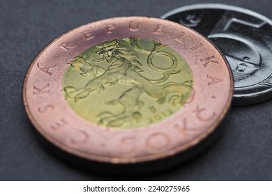 Translation: 50 crowns Czech Republic. Coin illustration for news about economy or finance. Czech money close up lie on a dark surface. Crown and national currency of Czechia. Macro