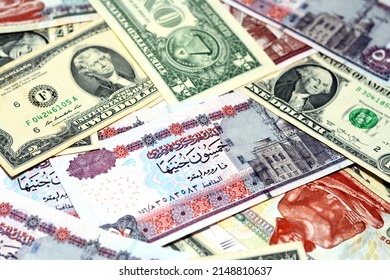 Translation of the Arabic text ( fifty Egyptian pounds), A pile of American dollars and Egyptian pounds background, a stack of 50 LE, 200 LE, 1 $ and 2 $, American and Egyptian money exchange rate