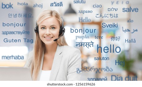 Translation, Business And Technology Concept - Smiling Female Translator Or Operator In Headset At Office Over Greeting Words In Different Foreign Languages