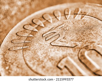 Translation: Rupee. Fragment Of Indian 10 Rupee Coin With The Sign Of The National Currency Close-up. Brown Tinted Background From Money About Economy Or Finances Of India. Macro