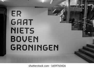 Translation "there is nothing above Groningen": Sign of the pay off of the city Groningen written on a white wall, black and white