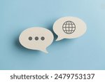 For translator application,  foreign languages concept, top view of real  white speech bubble paper with  on blue background