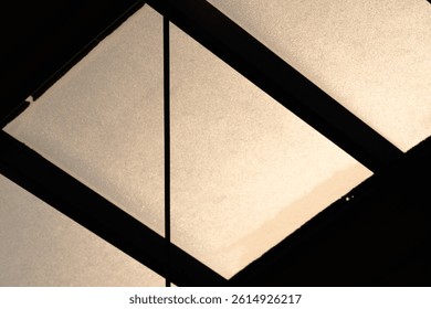 Translucent Ceiling Panels with Harsh Diagonal Shadows at Sunset