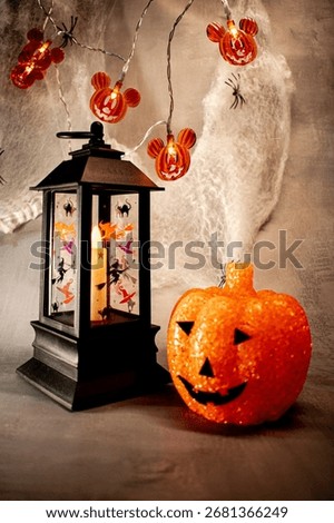 Translucent orange jack-o’-lantern with a textured bubble surface sits on artificial snow. Neutral gray background enhances its warm glow, blending Halloween charm with a hint of winter magic.