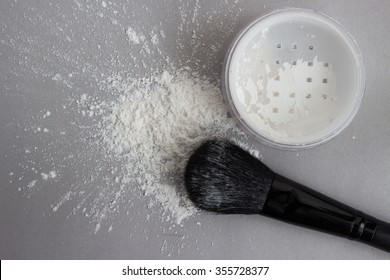 translucent powder and brush on gray background - Shutterstock ID 355728377