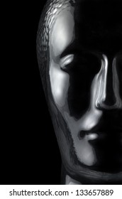 translucent reflective human head made of glass in black back