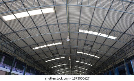 Translucent tiles on the roof. Sunlight shines through the translucent domed roof sheet with a metal structure in bottom view with a copy area. Selective focus - Shutterstock ID 1873030627