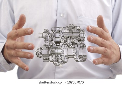 transmission with gears and shafts between the hands of the engineer on the background against the back of stomach Digestive system to the internal organs or process improvement programs trasmissii