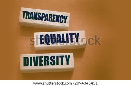 Transparency Equality diversity words on long wooden blocks on black background. Equality concept by gender, ethnicity and age.