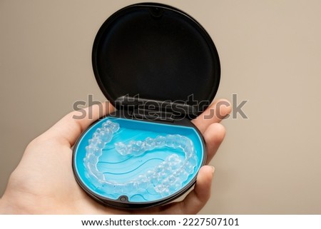 Transparent aligners and storage case box. Invisible braces. Clear teeth straighteners. Plastic bracers