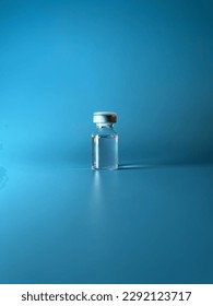 Transparent ampoule on a blue background. Contains medical supplies, drug, liquid or vaccine. One vial for medicine, aesthetic medicine treatment. Verticale - Shutterstock ID 2292123717