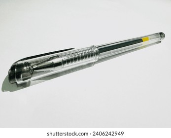 Transparent Ballpoint Pen. Clear plastic ballpoint pen with a yellow accent on a bright background.