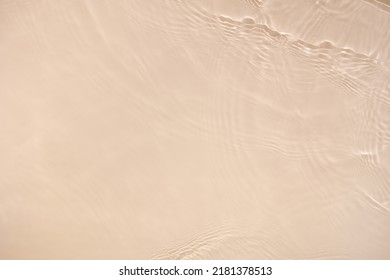 Transparent beige clear water surface texture with ripples, splashes. Abstract nature background Water waves in sunlight with copy space, top view. Cosmetic moisturizer micellar toner emulsion - Shutterstock ID 2181378513