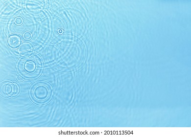 Transparent blue colored clear water surface texture with ripples, splashes and bubbles. Abstract nature background Water waves in sunlight with copy space Cosmetic moisturizer micellar toner emulsion - Shutterstock ID 2010113504
