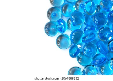 Transparent blue glass marble beads isolated on white background. Acrylic ice stones for decoration. Water drops. Abstract wallpaper or backdrop for web design