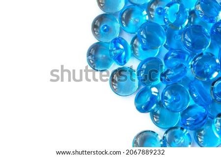 Transparent blue glass marble beads isolated on white background. Acrylic ice stones for decoration. Water drops. Abstract wallpaper or backdrop for web design
