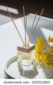 Transparent Bottle Of Aroma Diffuser On The Terazzo Podium On White Background. Eau De Parfum For Home Presentation On A Podium With Field Flowers. Trending Concept In Natural Materials.