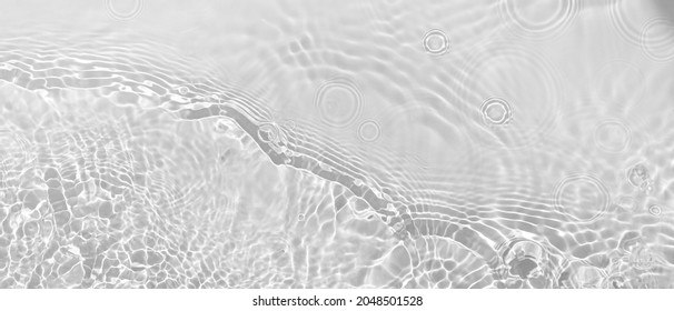 Transparent clear white water surface texture with ripples, splashes and bubbles. Abstract summer banner background Water waves in sunlight with copy space Cosmetic moisturizer micellar toner emulsion - Shutterstock ID 2048501528