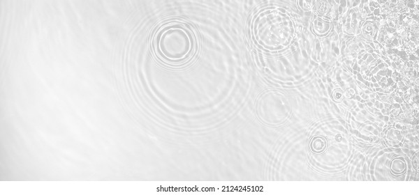 Transparent clear white water surface texture with ripples, splashes and bubbles. Abstract summer banner background Water waves in sunlight with copy space Cosmetic moisturizer micellar toner emulsion - Shutterstock ID 2124245102