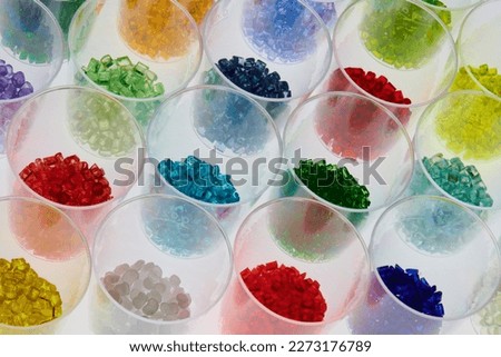 transparent colored plastic resins in test glasses in laboratory