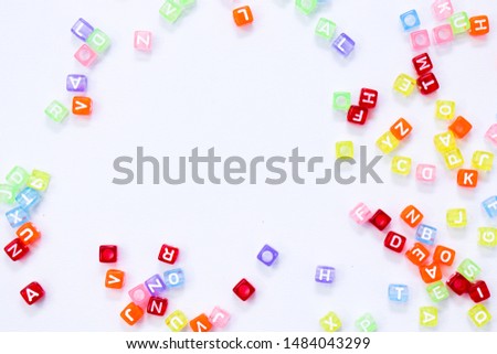 Transparent and Colorful Letter Beads on White Background. Flat Lay. High Resolution Photo. 