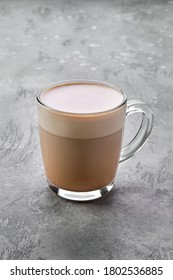 Transparent cup of cappuccino with foam