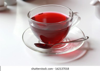 Transparent cup of red fruit tea on the table - Shutterstock ID 162137018