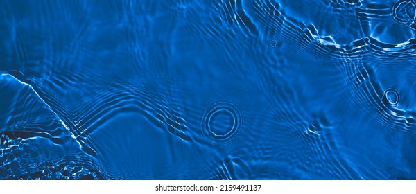 Transparent dark blue clear water surface texture with ripples and splashes. Abstract summer banner background Water waves with copy space, top view Cosmetic moisturizer micellar toner emulsion - Shutterstock ID 2159491137