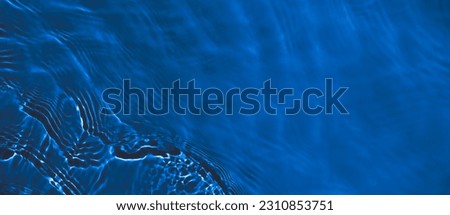 Transparent dark blue clear water surface texture with ripples and splashes. Abstract summer banner background Water waves with copy space, top view Cosmetic moisturizer micellar toner emulsion