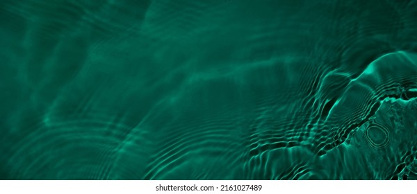 Transparent dark green clear water surface texture with ripples and splashes. Abstract summer banner background Water waves with copy space, top view. Cosmetic moisturizer micellar toner emulsion - Shutterstock ID 2161027489