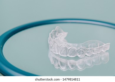 Transparent dental orthodontics to correct dental alignment on mirror - Powered by Shutterstock