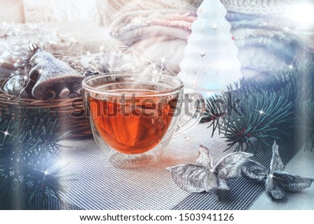 Transparent double bottom glass Cup with hot drink on table with Christmas decor. Warming drink in cold winter