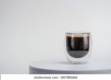 Transparent Double Wall Glass, With Black Coffee, On White Background. Cup With Black Liquid On White Rotating Table. Easy To Use For Advertising Branding And Marketing. 