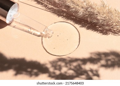 Transparent Drop Of Liquid Collagen, Peptide, Hyaluronic Acid For Skin Care On A Beige Background.