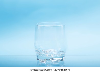 Transparent Empty Water Glasses With Blue Background.