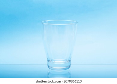 Transparent Empty Water Glasses With Blue Background.