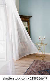 transparent fluttering curtain in the room with a candlestick on the table. romantic mood and spring weather. ventilation of premises. fresh wind. - Shutterstock ID 2139286649