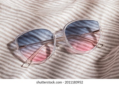 Transparent frame gradient sunglasses is gray striped cotton fabric