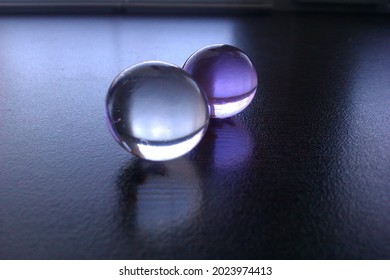 Transparent gel beads on an even dark surface - Powered by Shutterstock