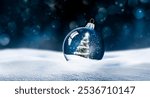 Transparent glass Christmas ball in snow