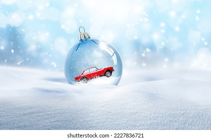 Transparent glass Christmas ball in the snow - Powered by Shutterstock