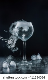 Transparent Glass With A Cocktail. Dry Ice. Black Background