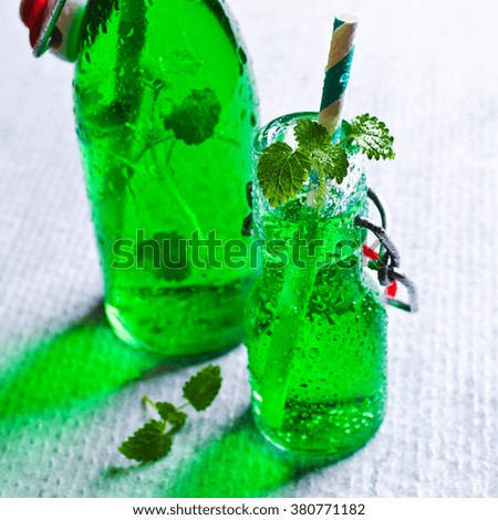 Transparent green drink in glass. Selective focus.