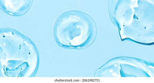 Transparent Hyaluronic Acid Gel Drops On A Blue Background.