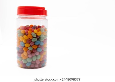 Transparent jar filled with multicolored jelly beans isolated on a white background - Powered by Shutterstock